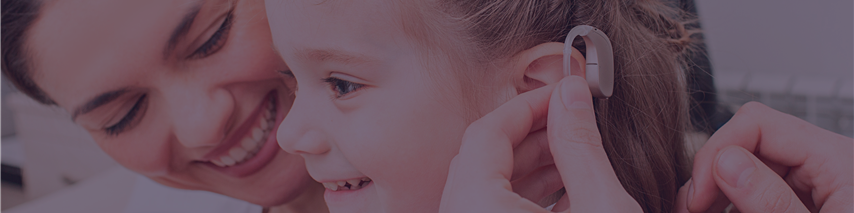 Mother happy her daughter is being fitted with hearing aid