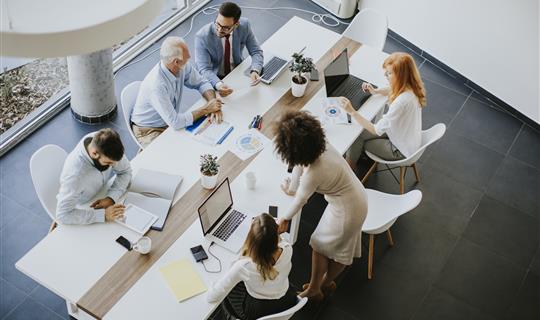 Top view of people busy working in meeting - modern office